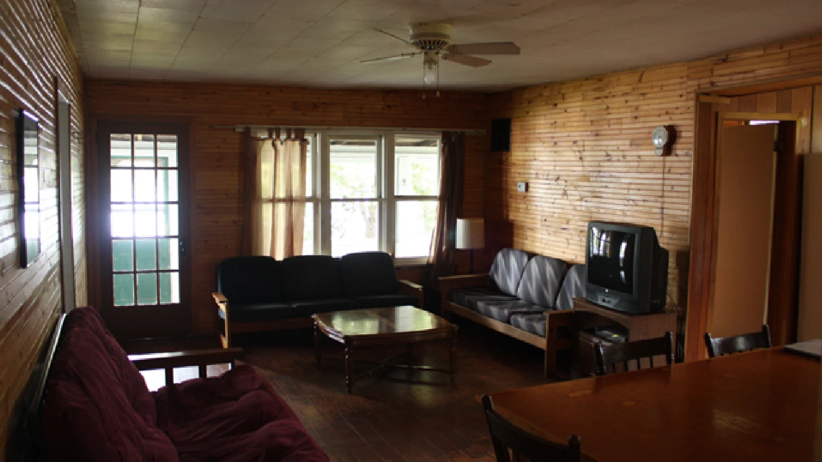 Pigeon Lake Resort Cottage two.&nbsp; Living room with sofas, coffee table, television, and wooden interior walls.